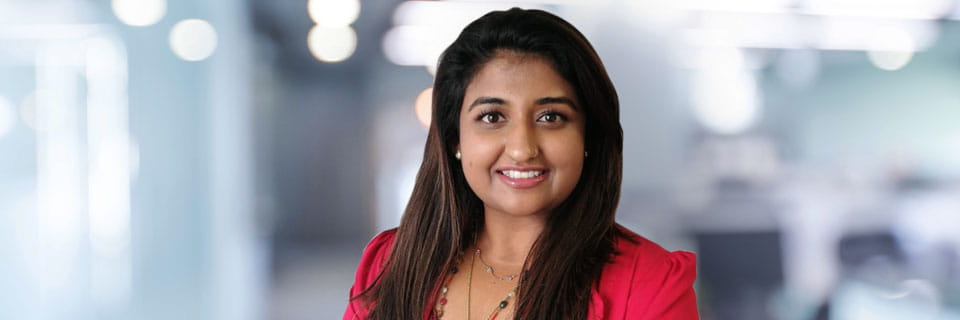 Indian female wearing red shirt smiling